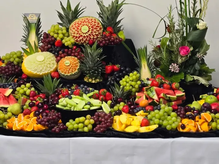 Elaborate fresh fruit display with hand-carved melon and pineapple