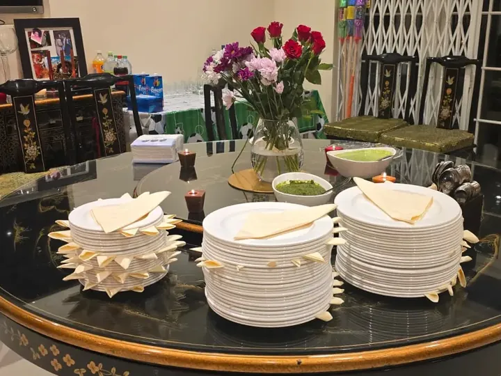 Table laid for a home celebration with plates and poppadoms