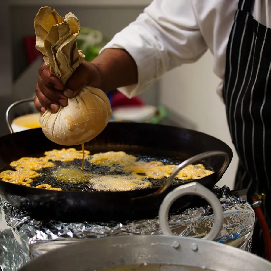 Fresh jalebi being fried in the kitchen