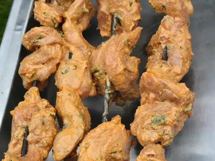 Marinated chicken tikka skewers ready for the grill