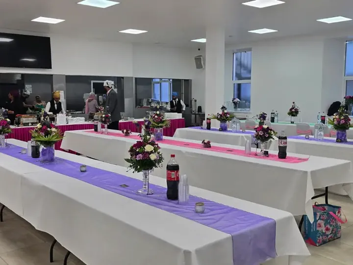 Wedding reception hall set up with floral centrepieces and buffet counters